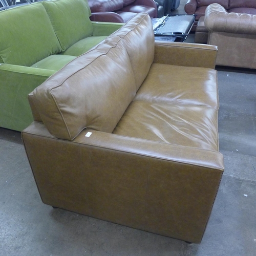 1490 - A tan vintage leather two and a half seater sofa with studwork, RRP £2850 * this lot is subject to V... 