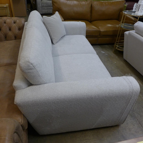 1494 - An ivory upholstered three seater sofa RRP £1099