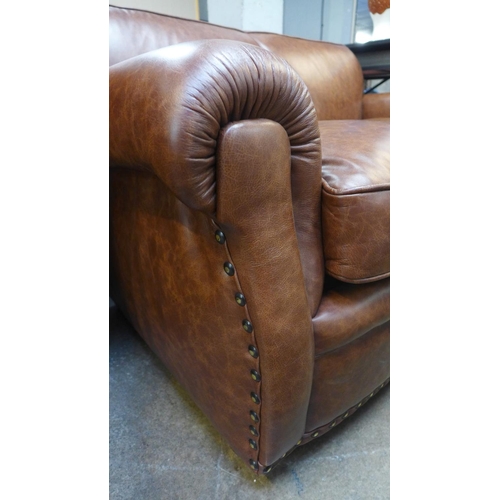 1496 - A Parisian dark tan leather two seater sofa with stud work , RRP £2155 * this lot is subject to VAT