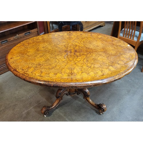 107A - A Victorian inlaid walnut oval tilt-top centre table