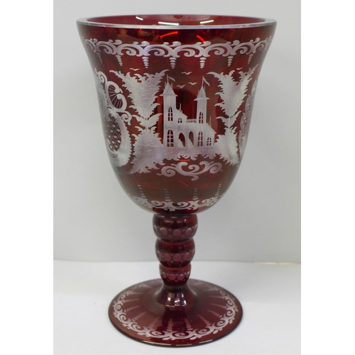 609 - A large red engraved Bohemian spa goblet etched with rural scenes, 21cm