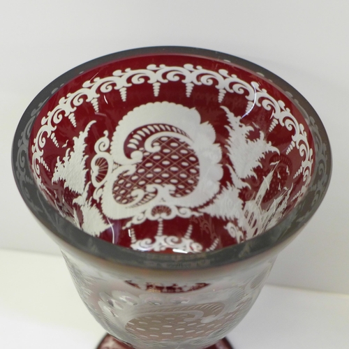 609 - A large red engraved Bohemian spa goblet etched with rural scenes, 21cm