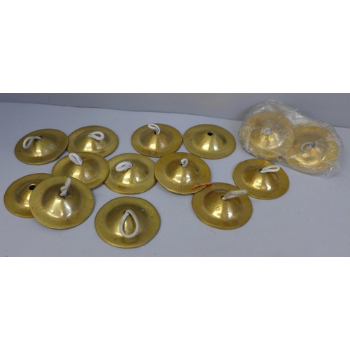 650 - Eight pairs of brass finger cymbals for belly dancing