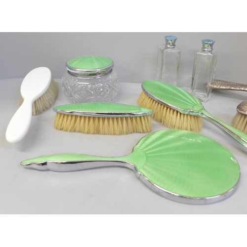 695 - A hand painted guilloche enamel dressing table set, silver backed brushes, Asprey brush and scent bo... 