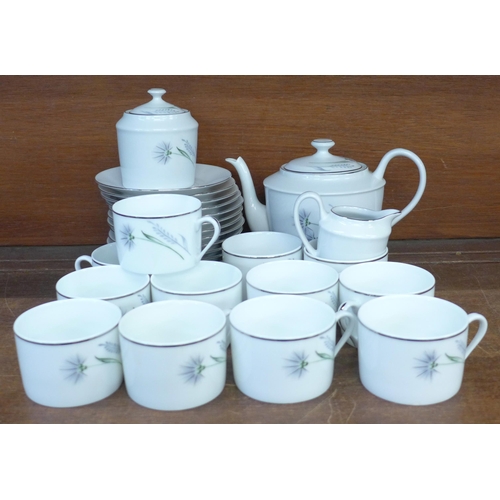 696 - A Limoges Chandon Gris platinum edged hand painted coffee set, twelve cups, saucers, a cream jug, su... 