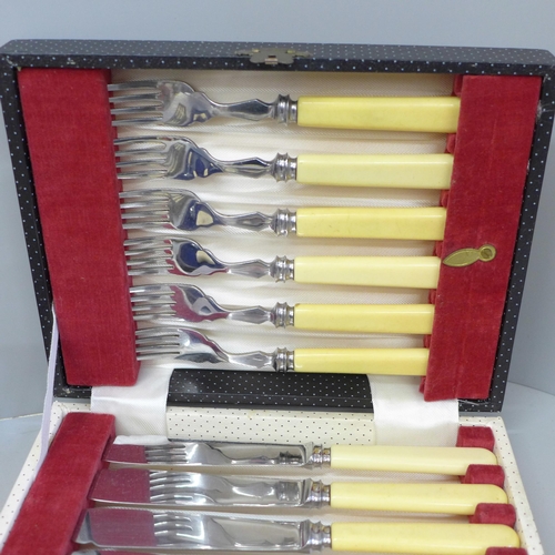 702 - A collection of plated, bone handled cutlery, fish knives withi silver collars