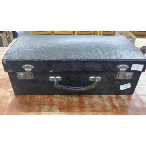 748 - A leather medical case containing a blood pressure monitor