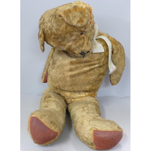 765 - A large plush jointed straw filled vintage Teddy bear, a/f