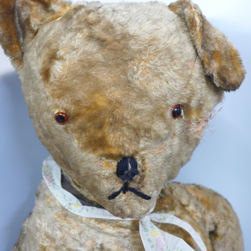 765 - A large plush jointed straw filled vintage Teddy bear, a/f