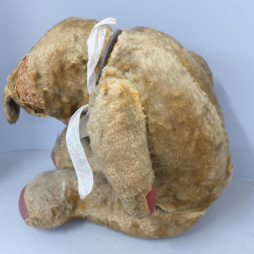 765 - A large plush jointed straw filled vintage Teddy bear, a/f