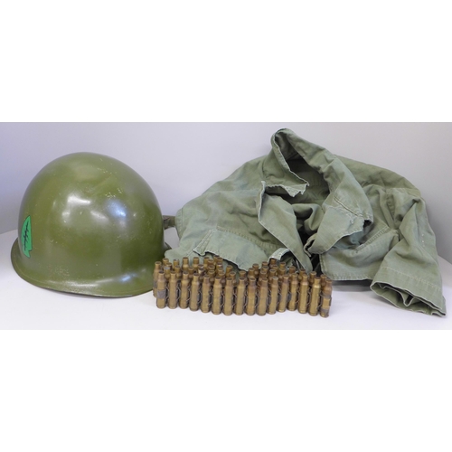 770 - A US M1 helmet, circa 1950 with bullet belt and US shirt