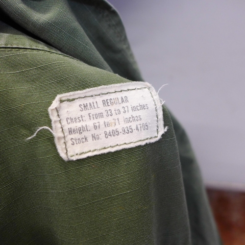 770 - A US M1 helmet, circa 1950 with bullet belt and US shirt