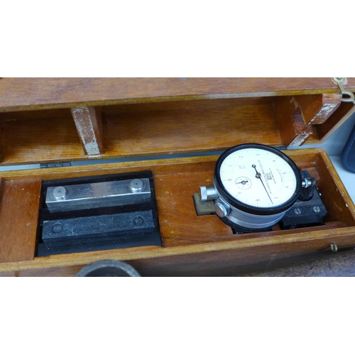 783 - A box of assorted items; brass clock, gauges, cigar cases