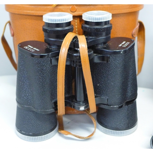 799 - A pair of Pentax binoculars, one other pair and a Canon camera