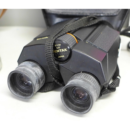 799 - A pair of Pentax binoculars, one other pair and a Canon camera