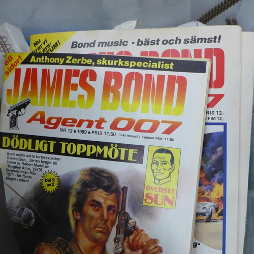 828 - A collection of James Bond toys, etc., including vehicles, a Corgi Toys Aston Martin, etc.