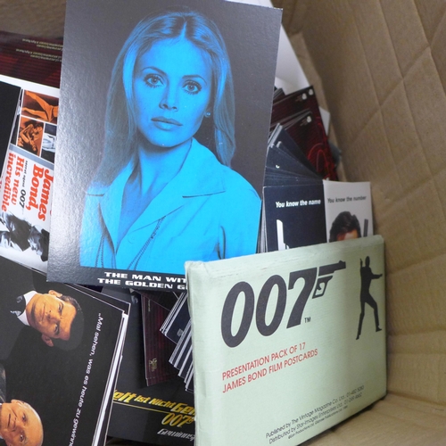 832 - A box of James Bond film postcards