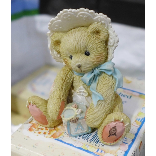 834 - A large collection of Cherished Teddies figures, approximately 33, boxed and a nursery display stand