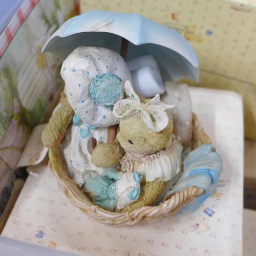 834 - A large collection of Cherished Teddies figures, approximately 33, boxed and a nursery display stand