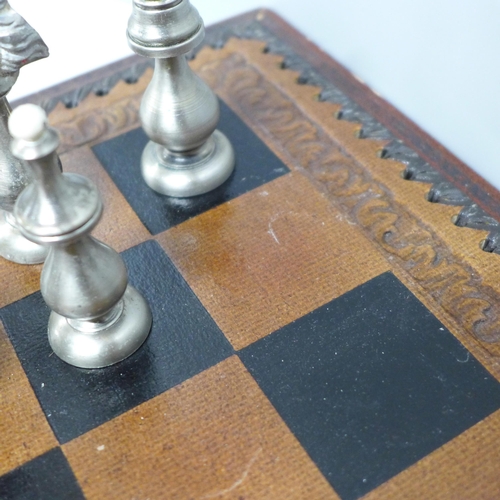 854 - A chess set and board, two metal pieces missing