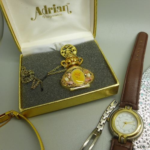 916 - A collection of lady's wristwatches, a belt and a scent bottle