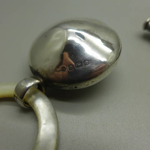 919 - A pearl and silver teething ring, Birmingham 1933 and a mother of pearl and silver teether/whistle