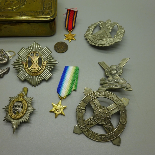 968 - A WWI Christmas tin containing military badges and medals