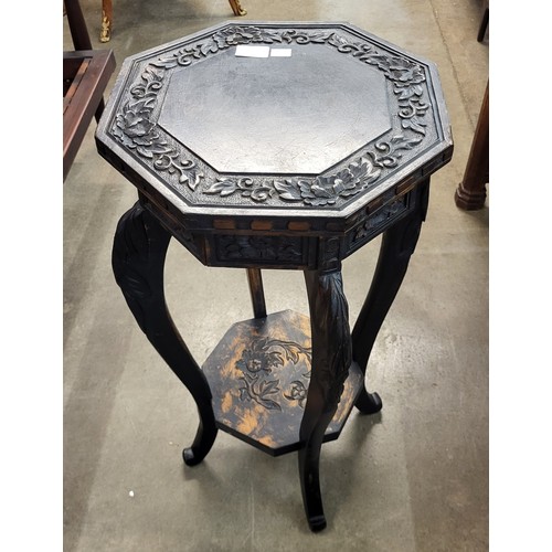 110 - A Chinese carved ebonised octagonal jardiniere stand