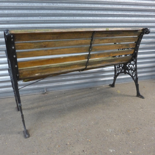 2291 - A wooden bench with cast iron bench ends