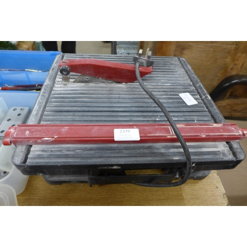 2379 - A tile cutter, casters, nuts, bolts, pens, etc.