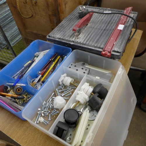 2379 - A tile cutter, casters, nuts, bolts, pens, etc.