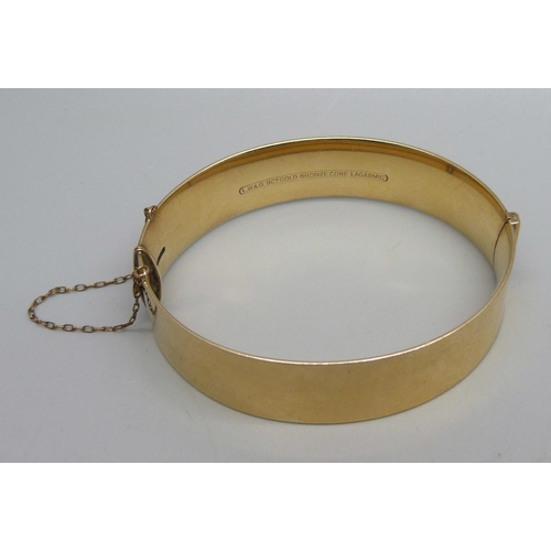 1024 - A 9ct gold on bronze core bangle, 41g