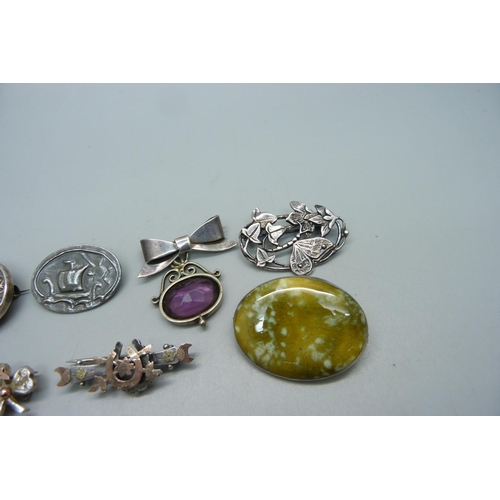 1044 - Three silver brooches including one with a ceramic plaque stamped 'Astra', white metal brooches and ... 