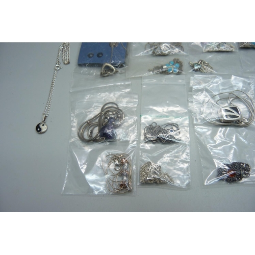 1045 - Twenty silver and silver mounted pendants and chains