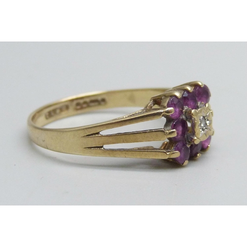 1050 - A 9ct gold ring set with purple stones and a central diamond, 2.5g, R, (two stones darker - possibly... 