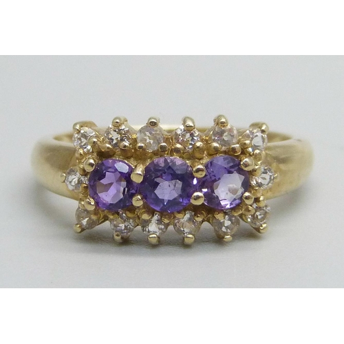 1053 - A 9ct gold ring set with three amethysts and white stones, 2.8g, N/O