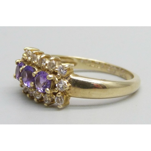 1053 - A 9ct gold ring set with three amethysts and white stones, 2.8g, N/O