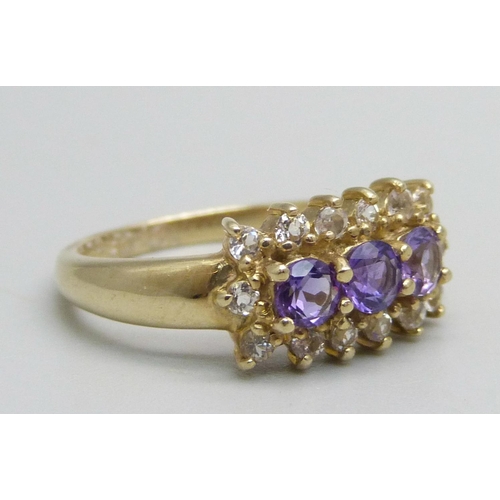 1053 - A 9ct gold ring set with three amethysts and white stones, 2.8g, N/O