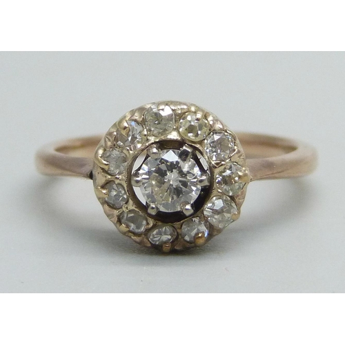 1059 - A yellow metal diamond cluster ring, 2.7g, M