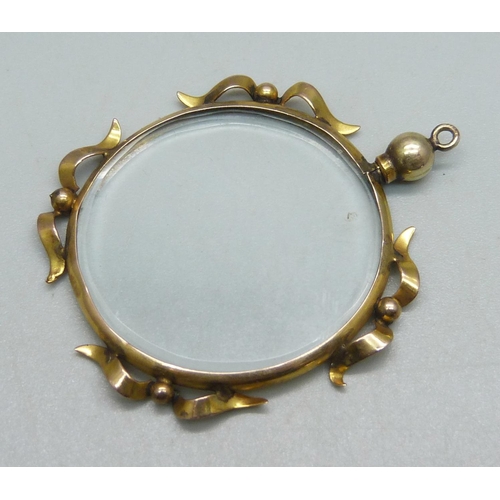 1076 - A yellow metal framed locket pendant, a/f bale loose, indistinct stamp, 4.5cm, 6.1g including glass