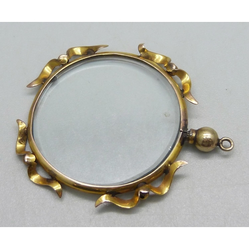 1076 - A yellow metal framed locket pendant, a/f bale loose, indistinct stamp, 4.5cm, 6.1g including glass