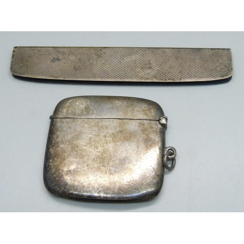 1078 - A silver vesta case with engraved initials, and a silver comb handle, 54g