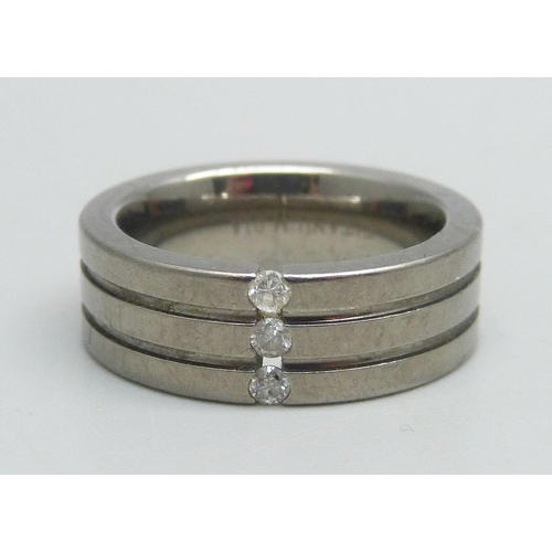 1087 - A titanium and three stone diamond ring, 0.12ct, with valuation, M/N