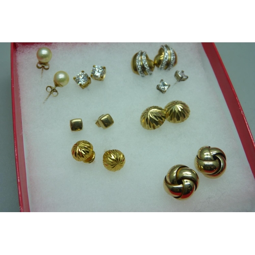 1088 - A pair of 9ct gold knot earrings, a pair of 9ct gold heart shaped earrings set with diamonds, a pair... 