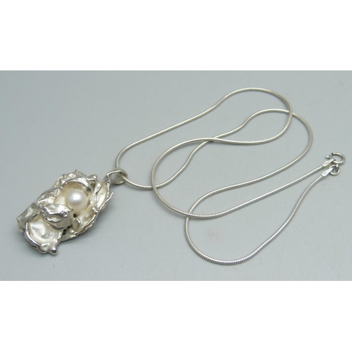 1094 - A modern water-cast silver pendant by Andrew Elliott, assayed for maker and set with a cultured pear... 