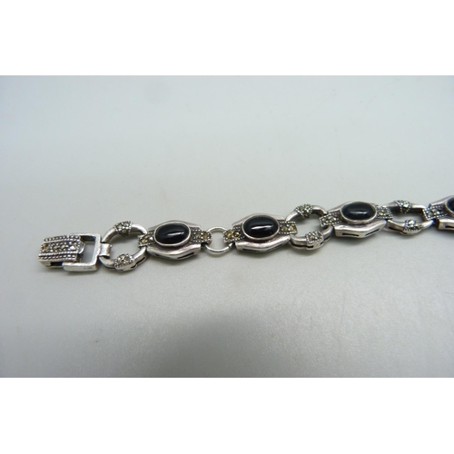 1120 - A silver bracelet set with marcasite and onyx, a/f missing stones and misshapen links with one unmat... 