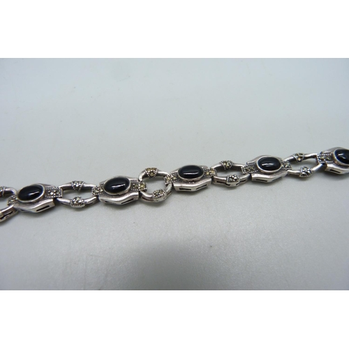 1120 - A silver bracelet set with marcasite and onyx, a/f missing stones and misshapen links with one unmat... 