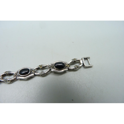 1120 - A silver bracelet set with marcasite and onyx, a/f missing stones and misshapen links with one unmat... 