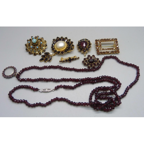 1128 - Six costume brooches and a necklace with a silver clasp