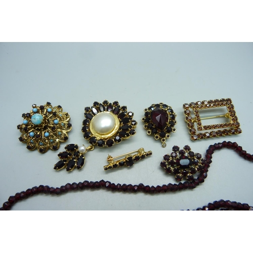 1128 - Six costume brooches and a necklace with a silver clasp